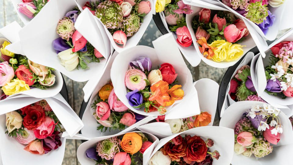 A collection of colorful flower bouquets wrapped in white paper, reminiscent of the blooms youd find at Niagara-on-the-Lake. These arrangements feature roses, peonies, and ranunculus in vibrant shades of pink, red, orange, yellow, and purple, creating a delightful visual symphony. 124 on Queen Hotel and Spa | Hotel & Spa Niagara-on-the-lake | 1 (855) 988-4552