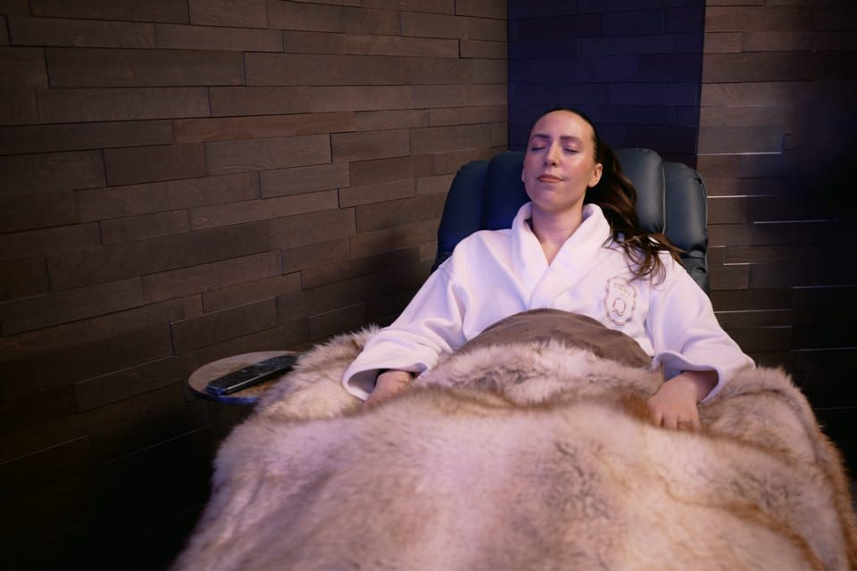 A woman in a white robe relaxes on a recliner, covered with a soft fur blanket, eyes closed and appearing peaceful, in a spa-like room with dark wooden walls. 124 on Queen Hotel and Spa | Hotel & Spa Niagara-on-the-lake | 1 (855) 988-4552 A woman in a white robe relaxes on a recliner, covered with a soft fur blanket, eyes closed and appearing peaceful, in a spa-like room with dark wooden walls. 124 on Queen Hotel and Spa | Hotel & Spa Niagara-on-the-lake | 1 (855) 988-4552